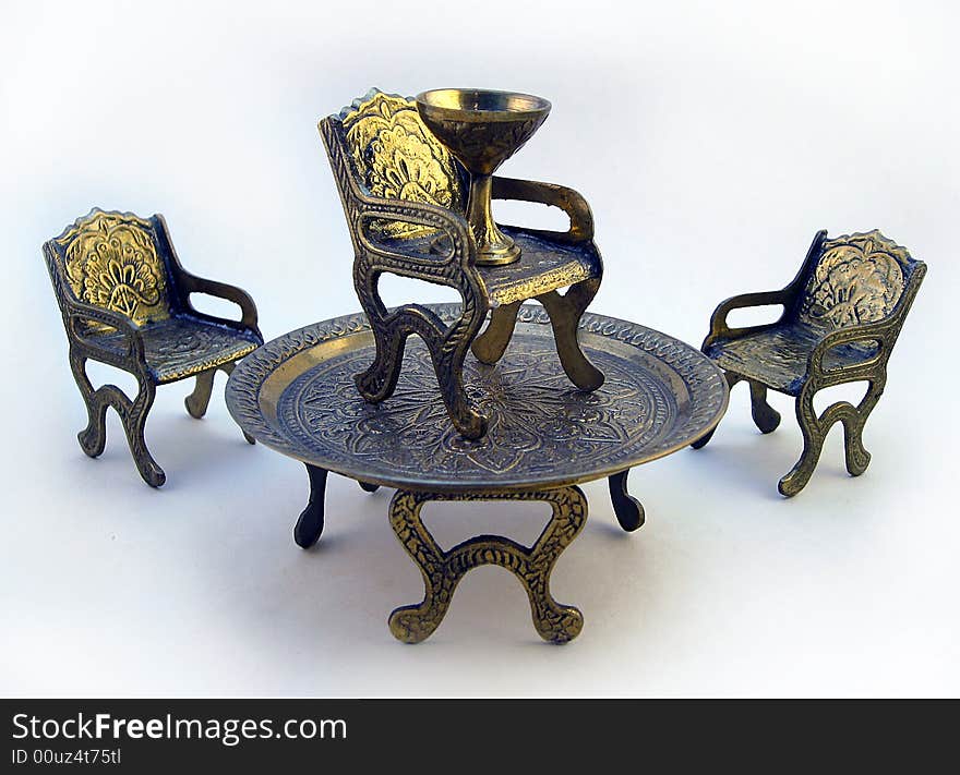 Three chairs, on of which on top of a table with chalice representing success. Three chairs, on of which on top of a table with chalice representing success