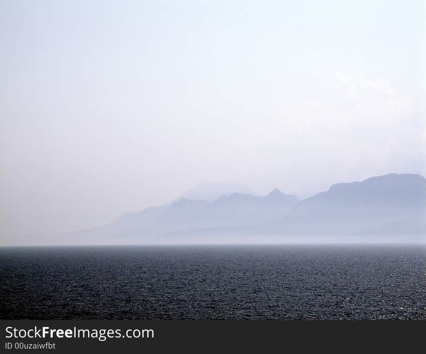 Sea scene in summer with mountains in the background. Sea scene in summer with mountains in the background