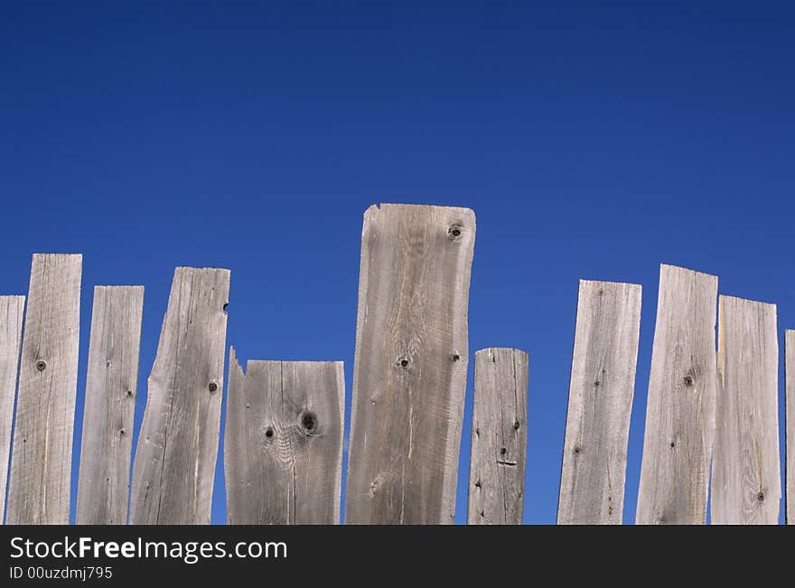 Weathered fence and blue sky