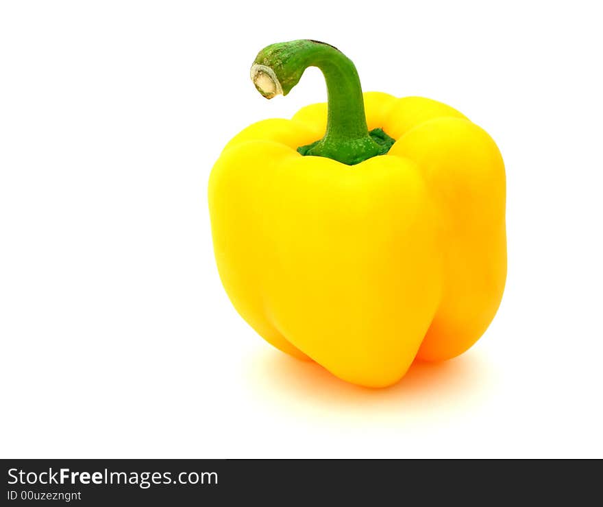 Fresh yellow pepper over a white surface