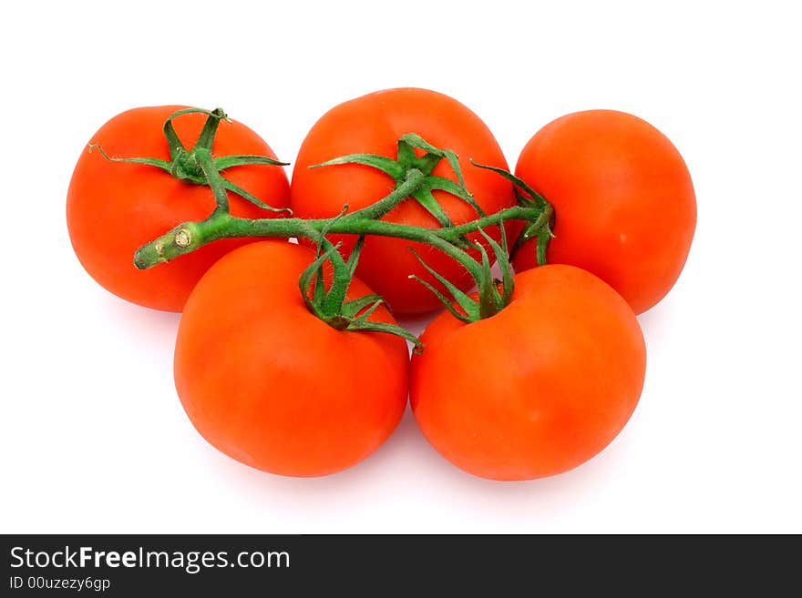 Five fresh and juicy tomatoes over a white surface