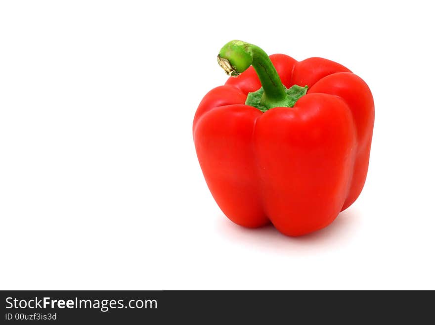 Fresh red pepper over a white surface