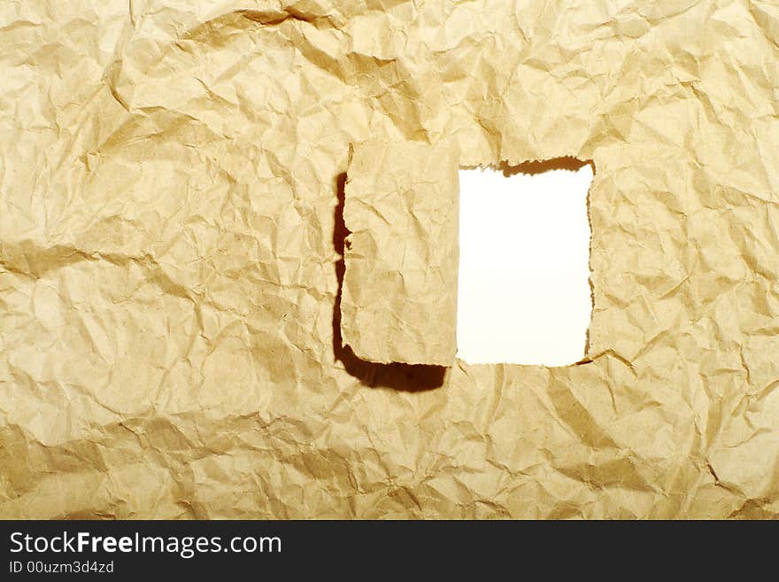 Old crushed a paper with a rectangular hole