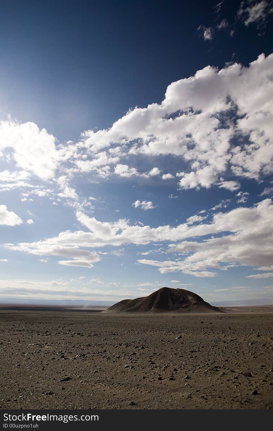 Wide-angle shot of a single rock in the Atacama Desert, Chile. Wide-angle shot of a single rock in the Atacama Desert, Chile.