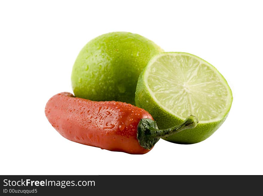 Two lime and a red chili isolated on white background