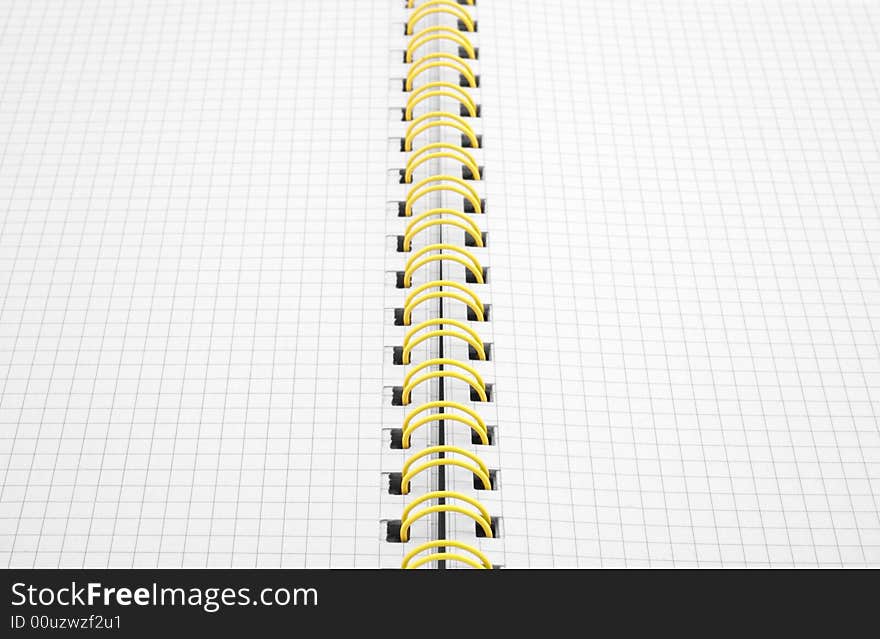 Close up of a spiral bound notebook with yellow spirals