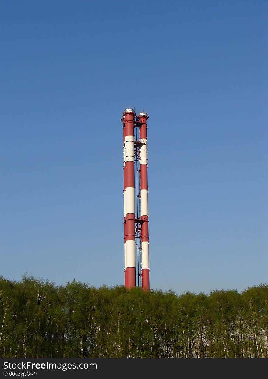 Chimneys of thermal power station on a background of the blue sky