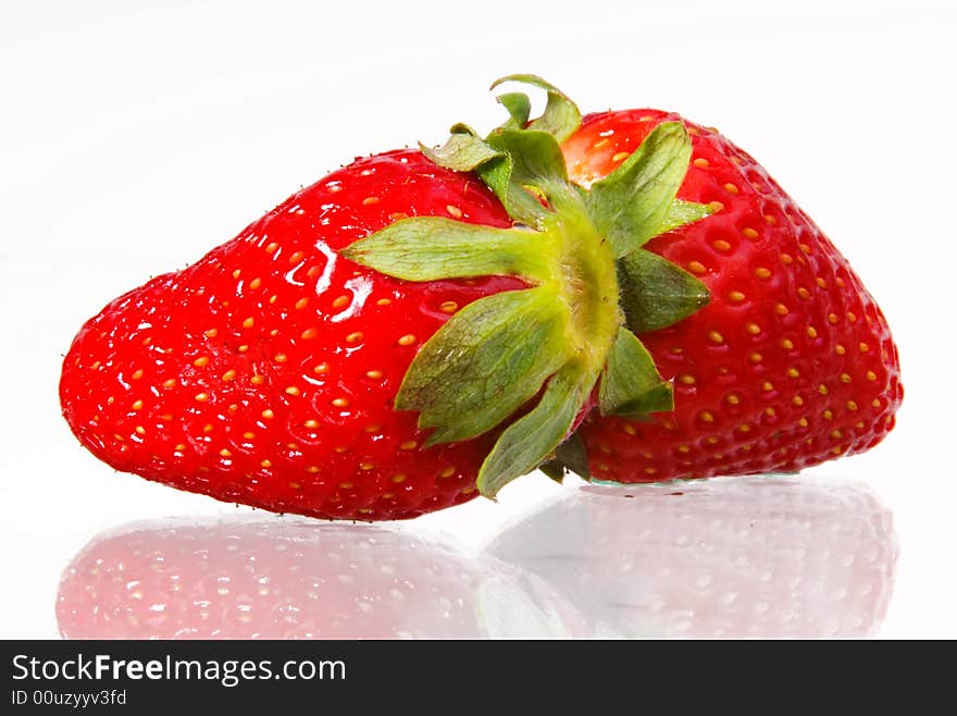 Pair of strawberries lying on glass, macro. Pair of strawberries lying on glass, macro