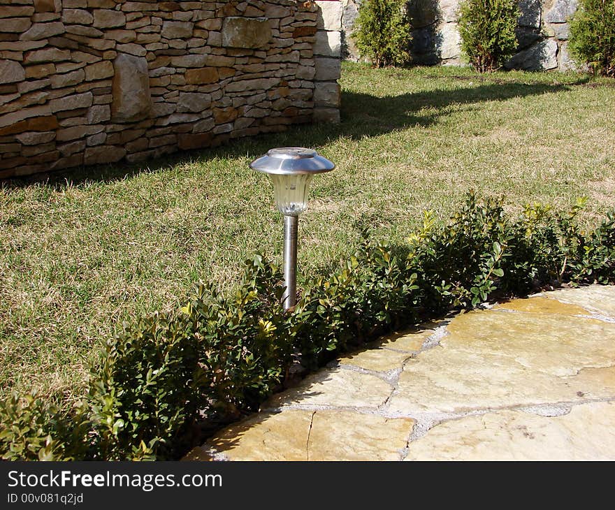 Garden stone path with grass growing up between the stones