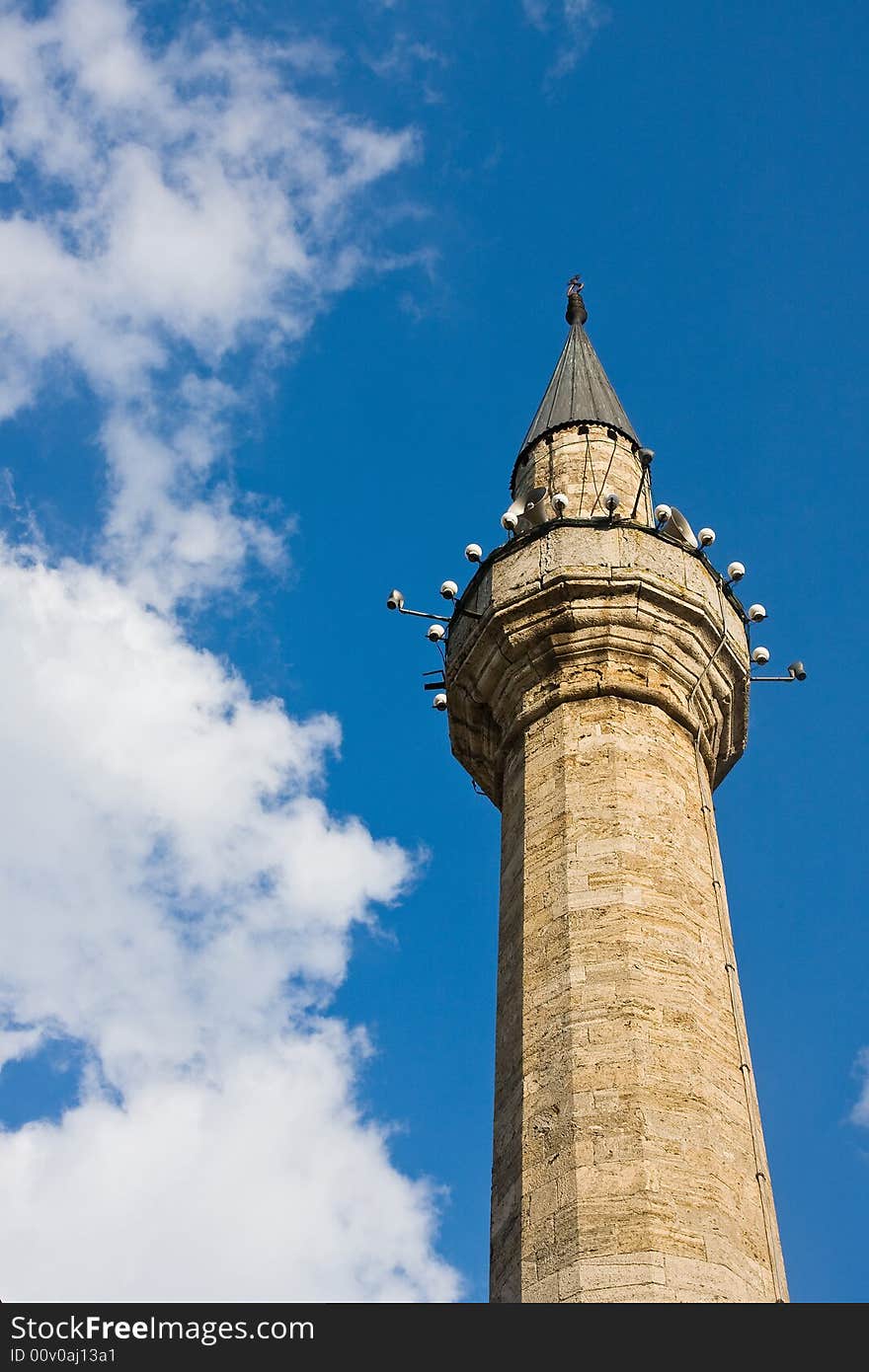 Single mosque minaret under the blue sky