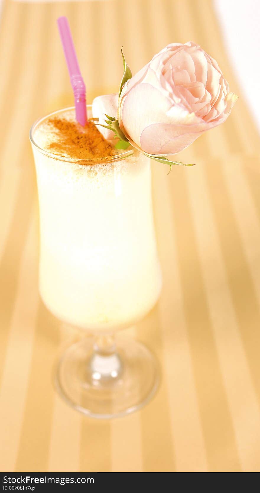 Creamy cocktail with a rose decoration