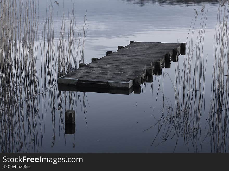 Bridge, floating on the calm lake. Bridge, floating on the calm lake