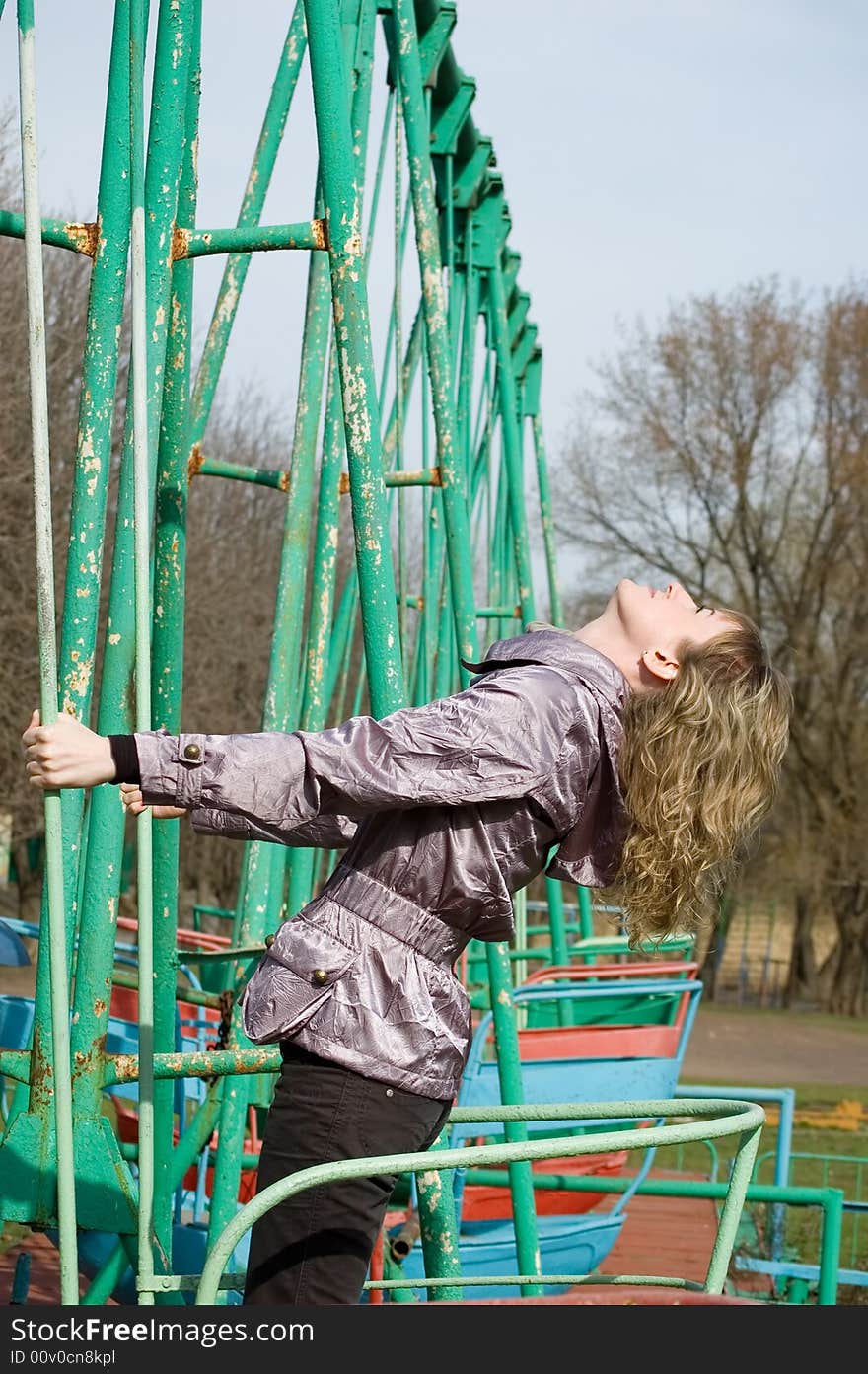 Girl in park on old swing