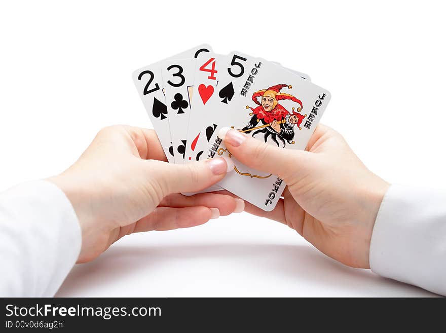 Woman hands holding playing cards with poker straight combination and a joker. Woman hands holding playing cards with poker straight combination and a joker