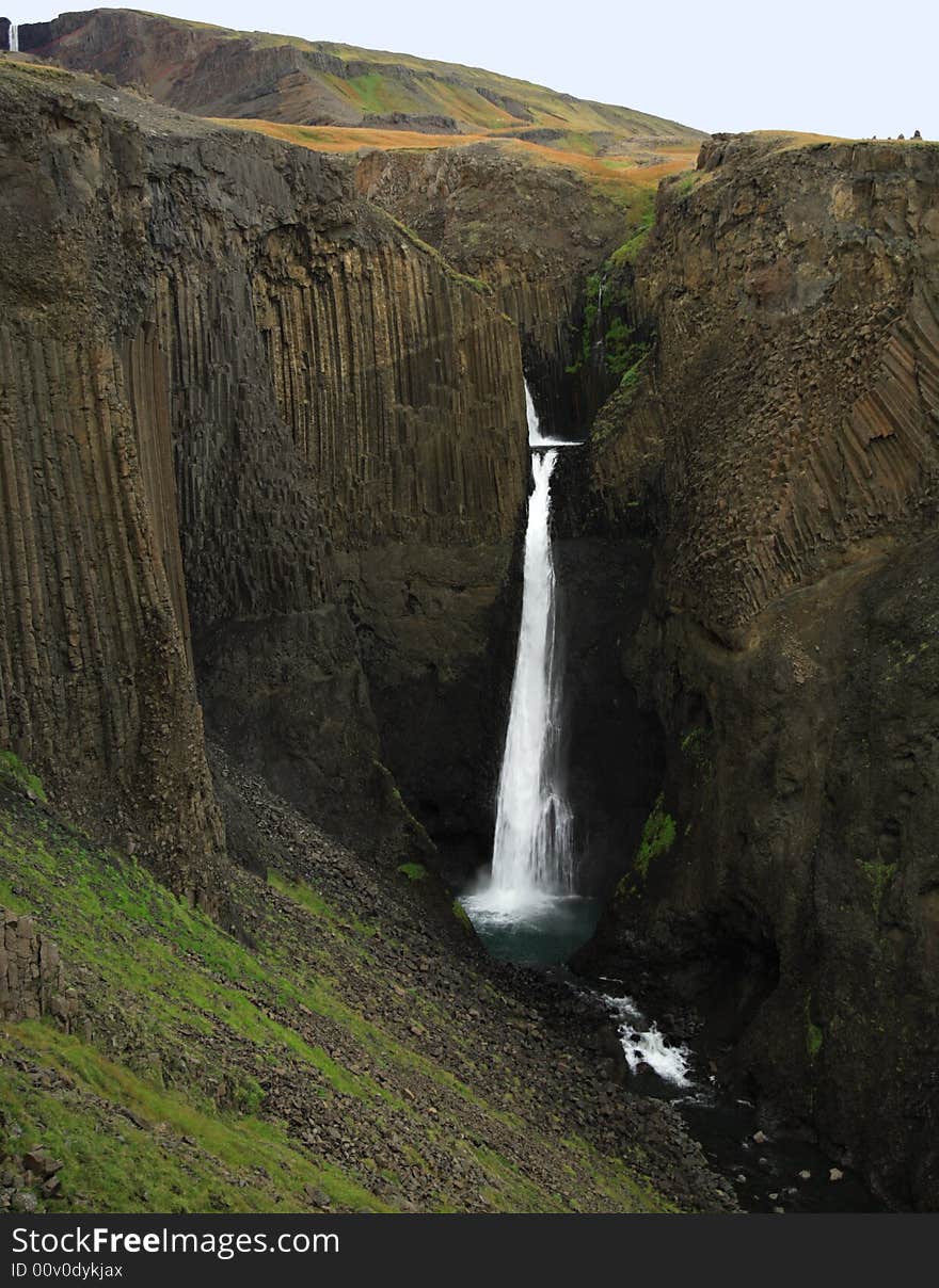 Tall Waterfall with basalt columns in Iceland. Tall Waterfall with basalt columns in Iceland