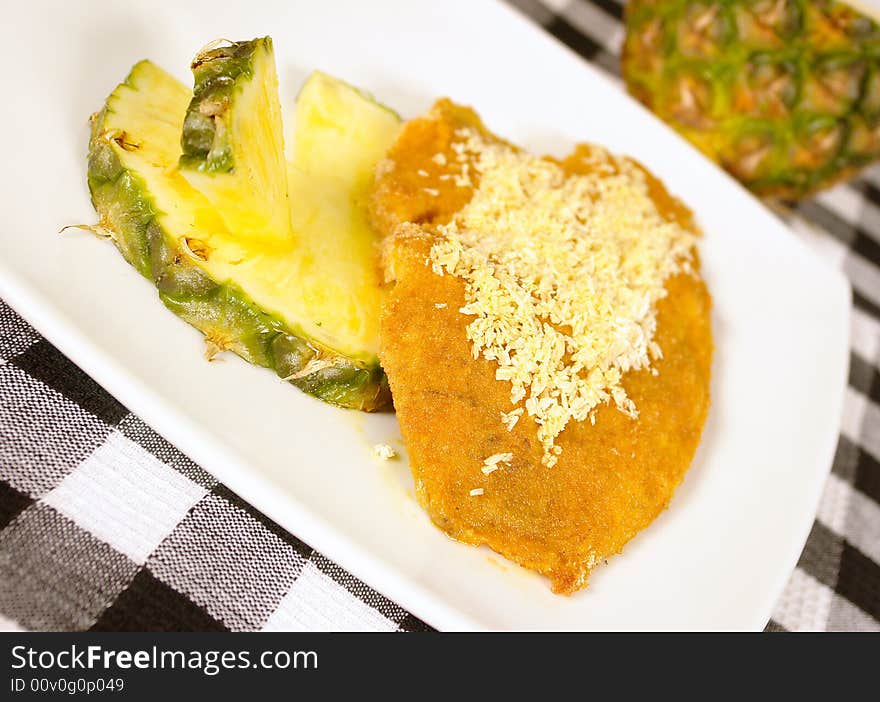 Breaded fish fillet with pineapple and coconut