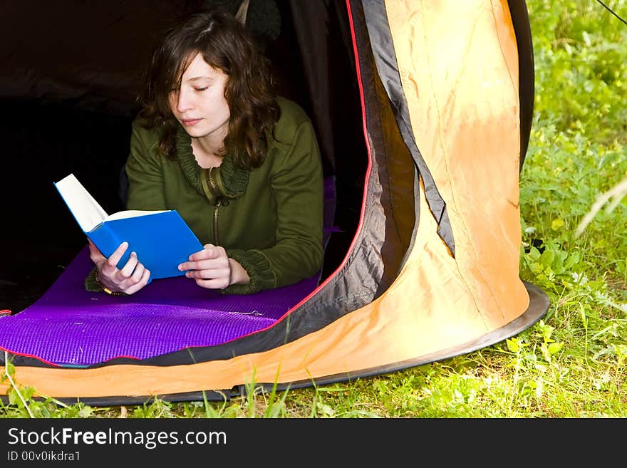 Young woman reading in the middle of the forest. Young woman reading in the middle of the forest