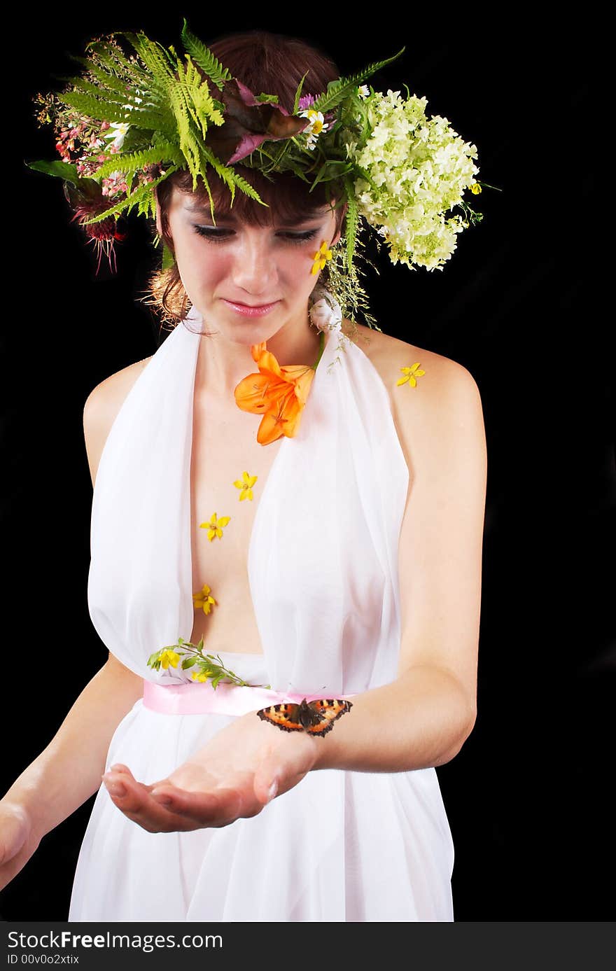 Girl in a wreath holds the butterfly. Girl in a wreath holds the butterfly