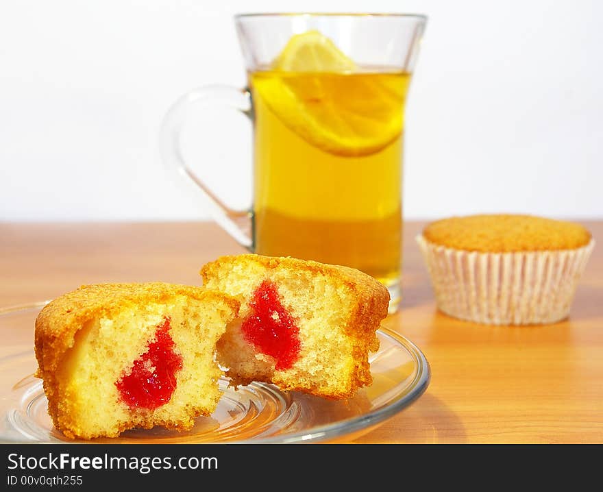 Cup of tea with the lemon abd cakes