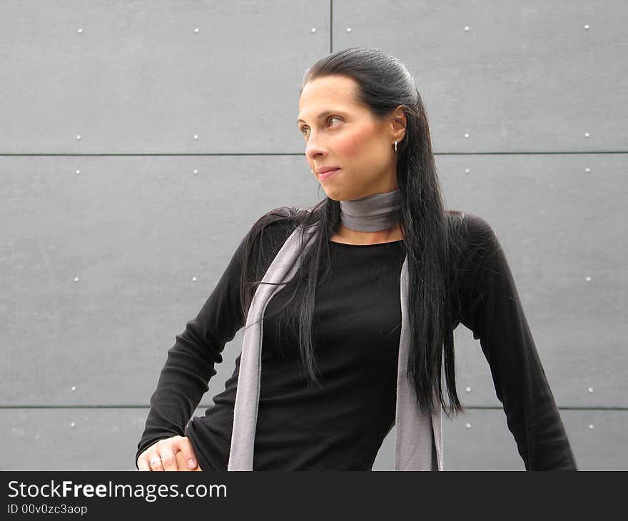 Long black hair woman against grey wall