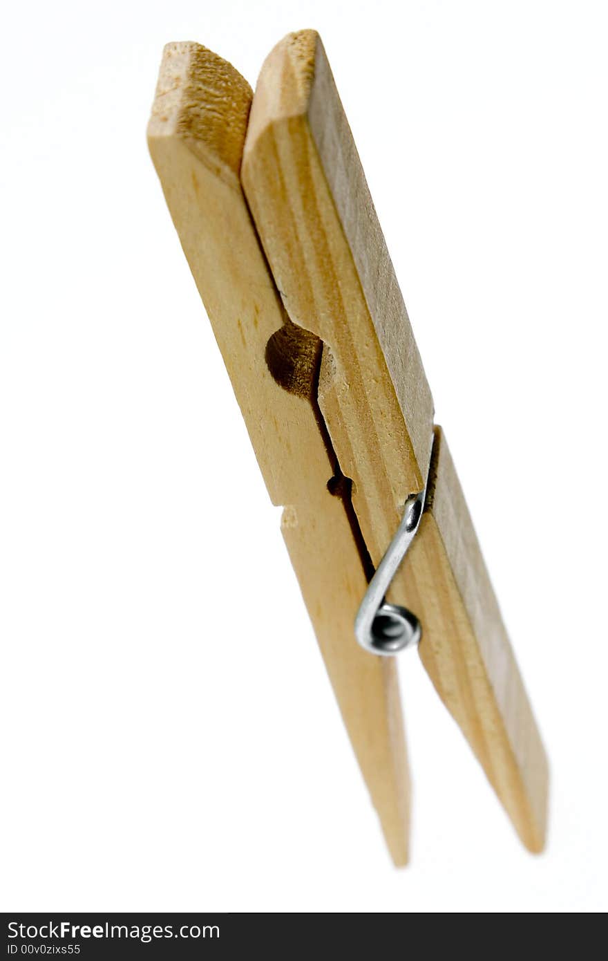 One isolated wooden clothespin (photo). One isolated wooden clothespin (photo)