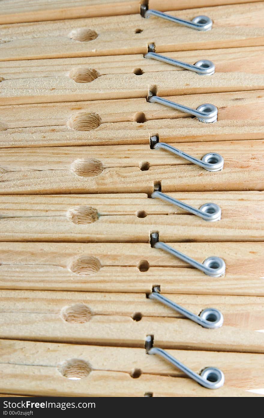 Eight isolated wooden clothespins in a row. Eight isolated wooden clothespins in a row