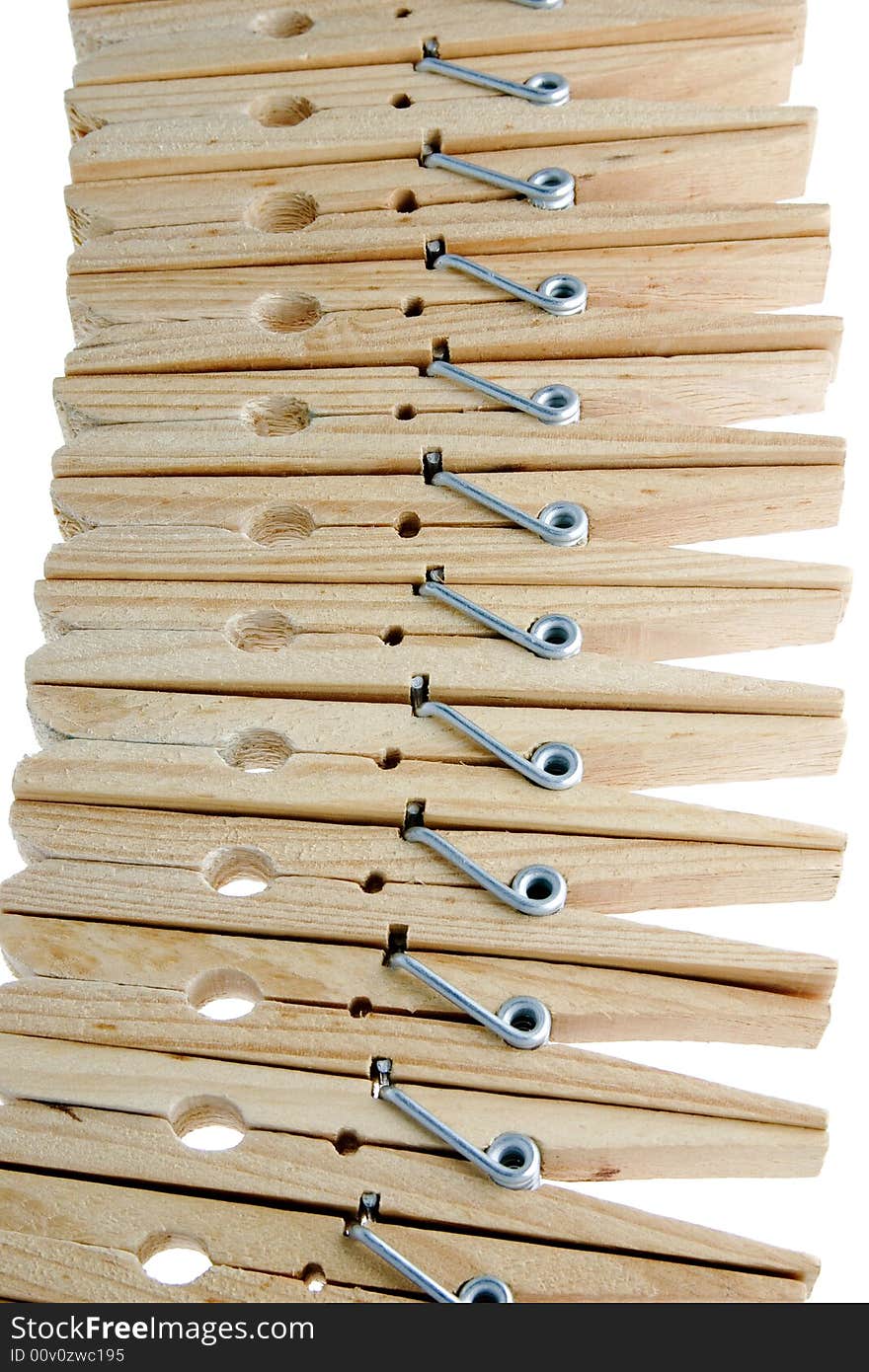 Twelve isolated wooden clothespins in a row. Twelve isolated wooden clothespins in a row