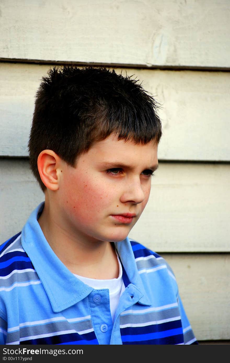 Moody teenager hanging around waiting for his friends