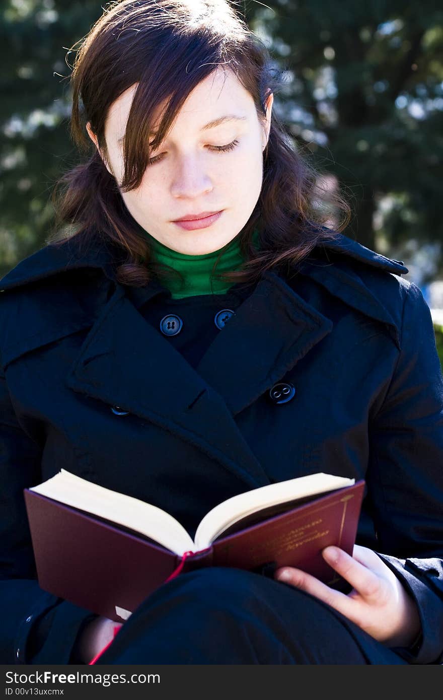 Young woman enjoying a book in the park. Young woman enjoying a book in the park