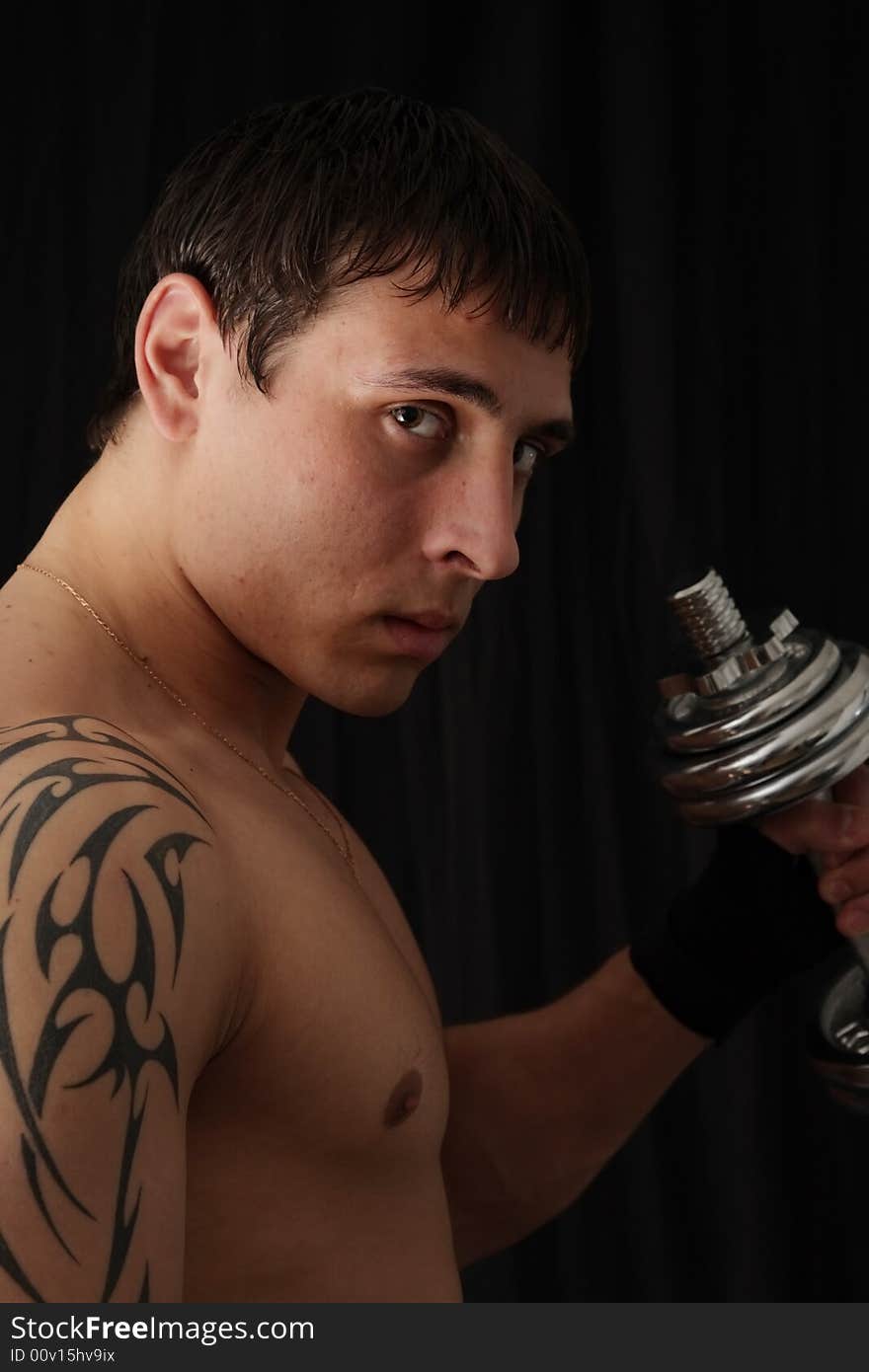 Portrait of a young man with the barbell. Portrait of a young man with the barbell.