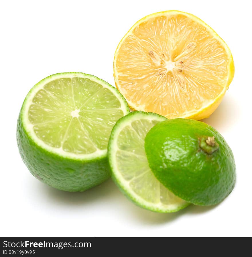 Lemon and lime on white. Segments of two citrus are mixed among themselves. Isolation, shallow DOF.