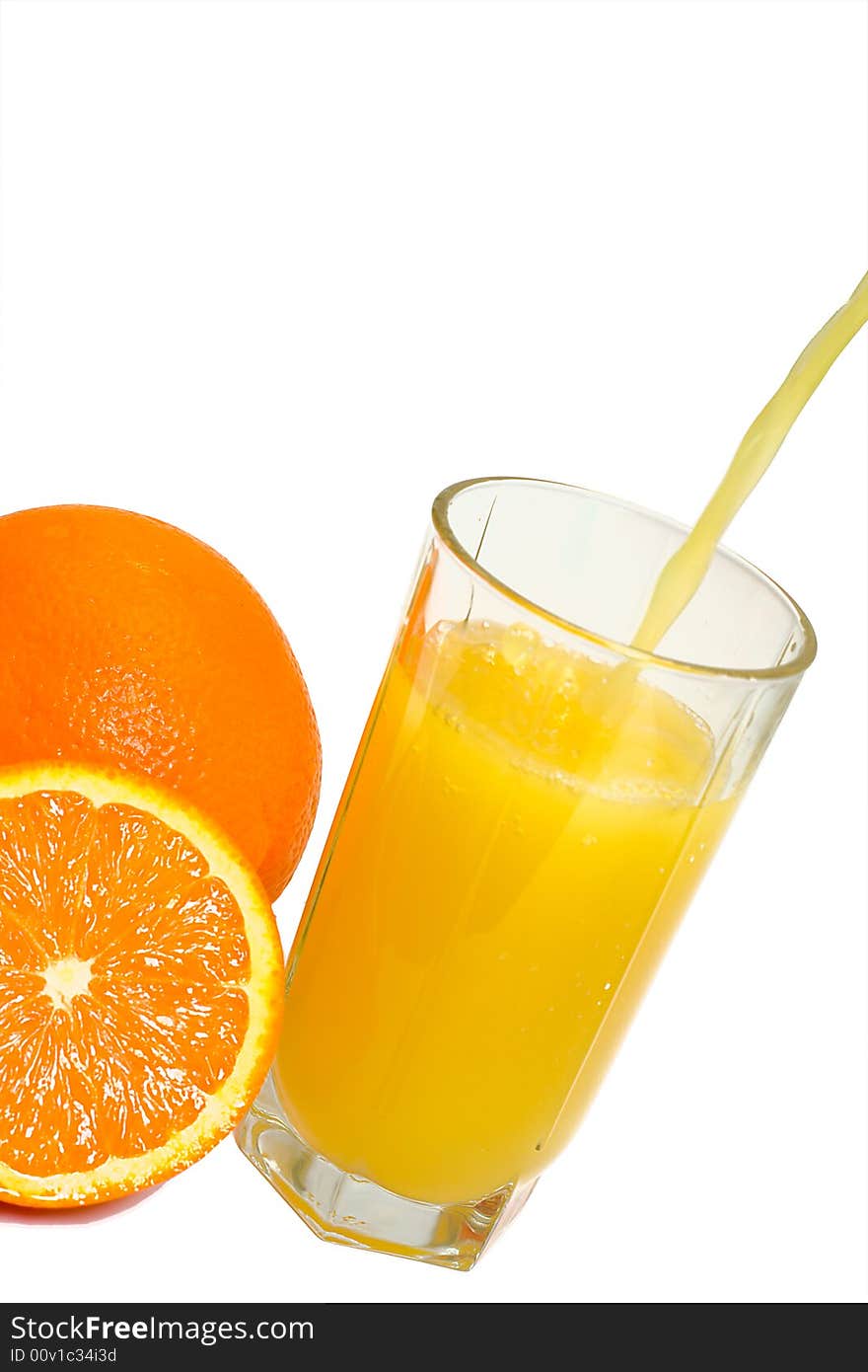 Oranges and glass filling with juice, isolated on white