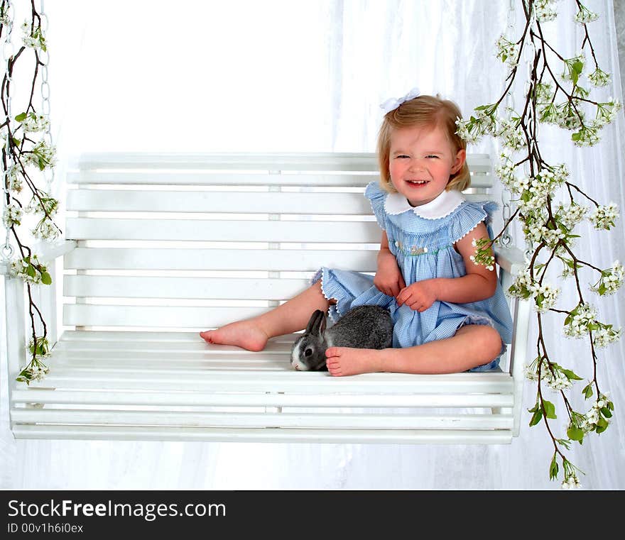 Smiling Girl and Bunny on Swing