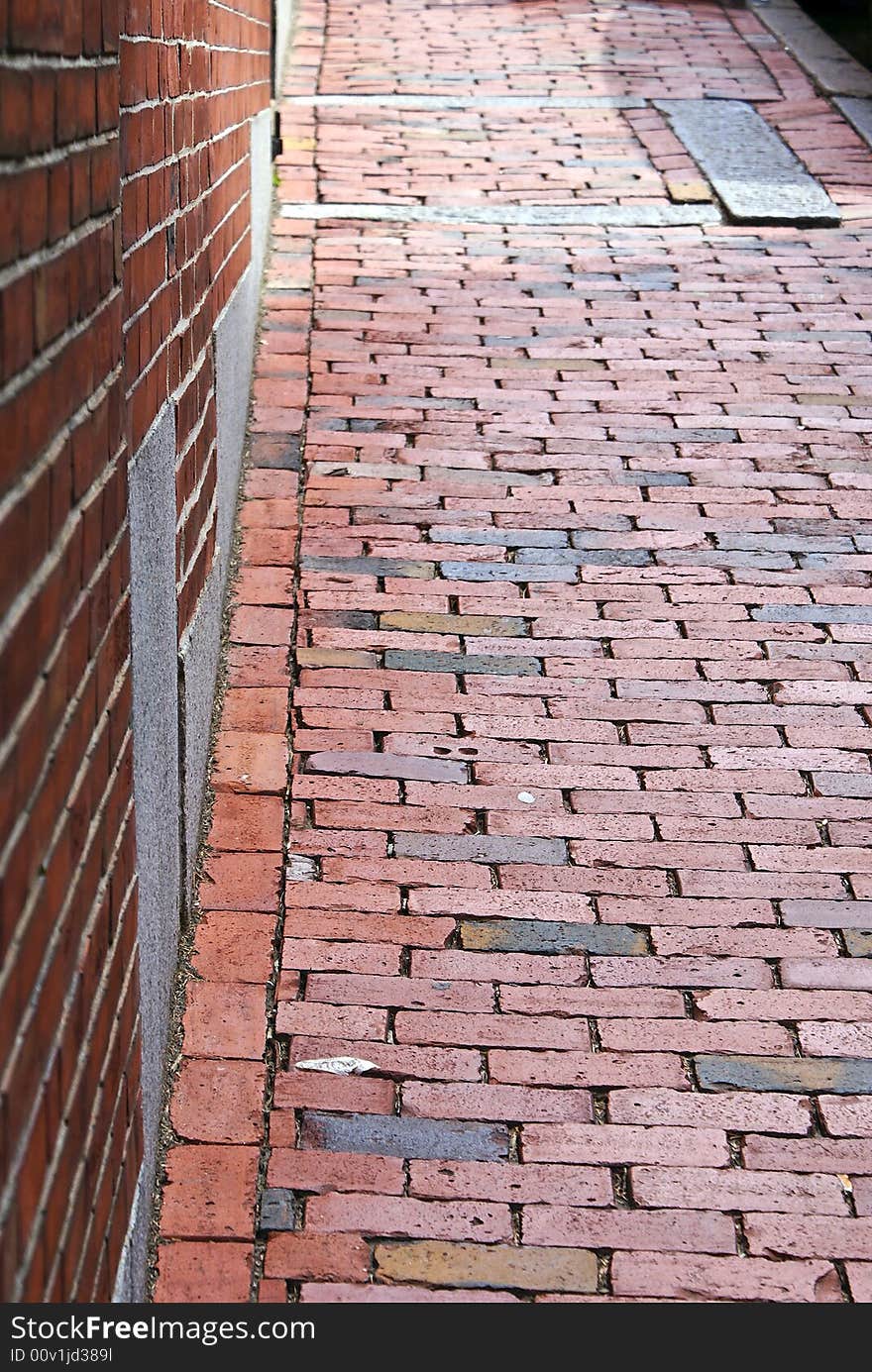 Brick wall with brick sidewalk, early america. Brick wall with brick sidewalk, early america