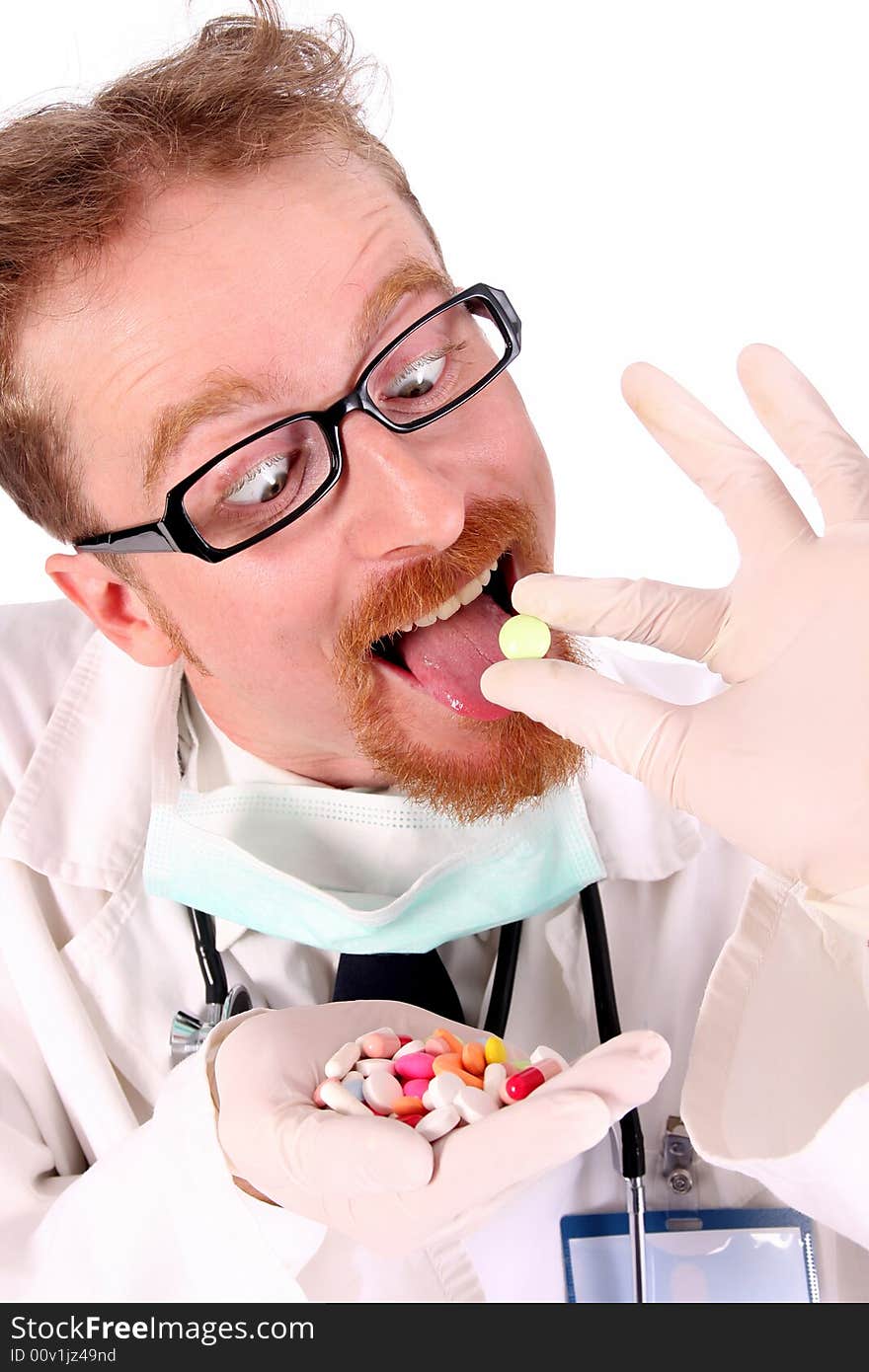 Doctor taking hand full of tablets on white background