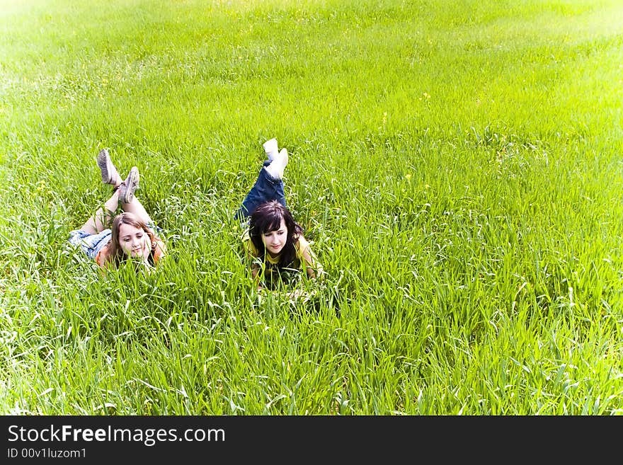 Two young friends enjoying on the grass. Two young friends enjoying on the grass