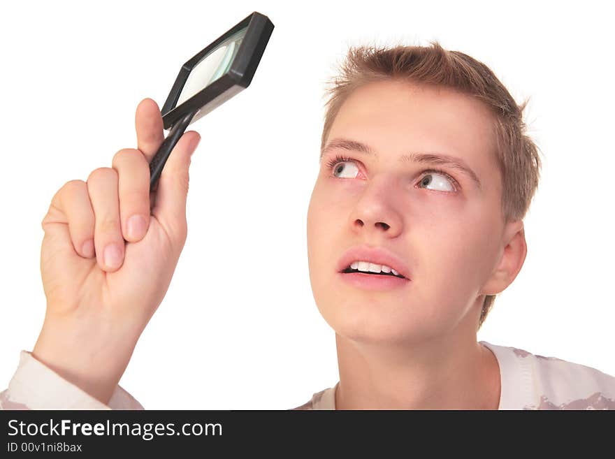 Young man looks through magnifier