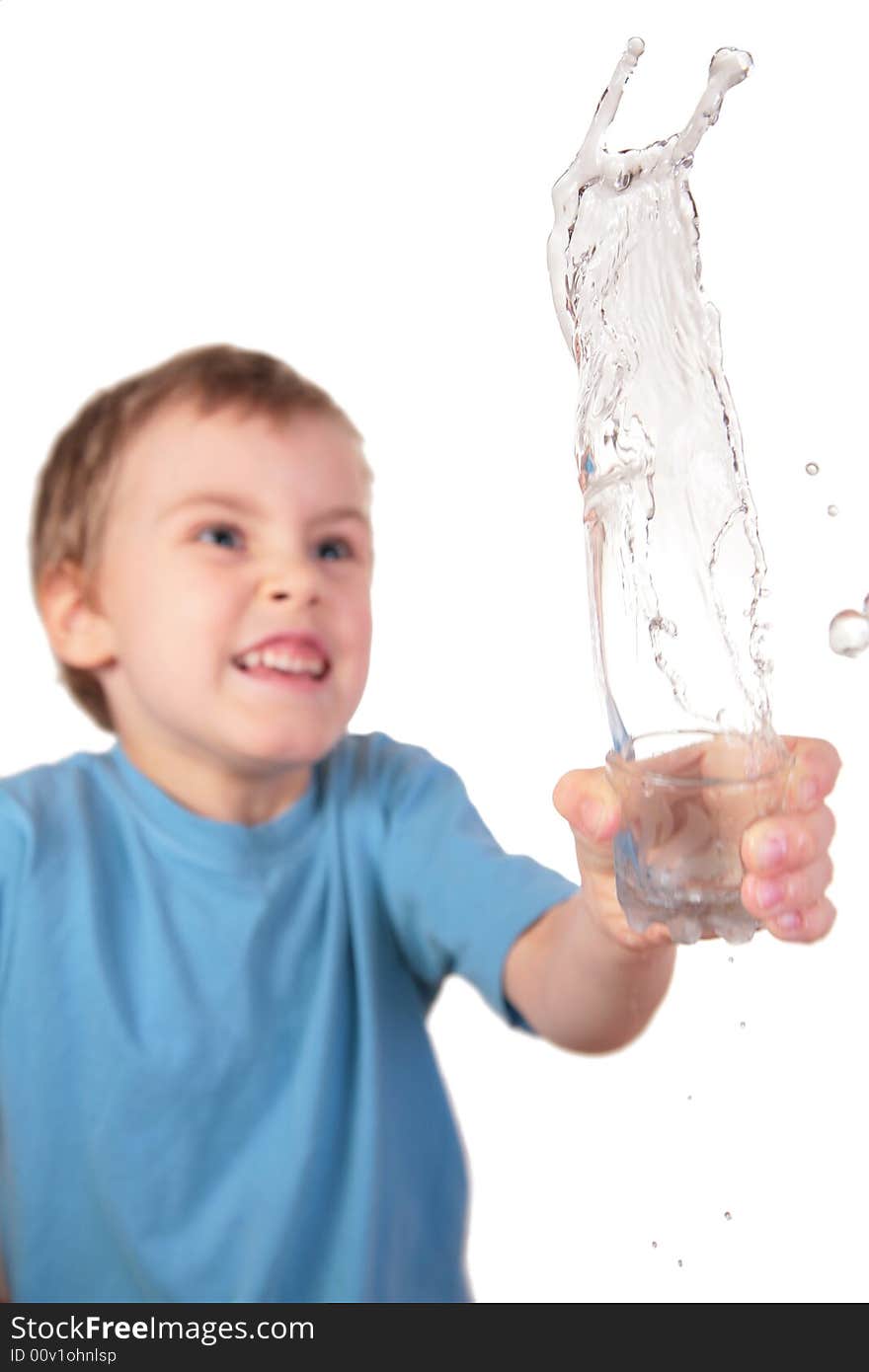Boy spills water from glass on white