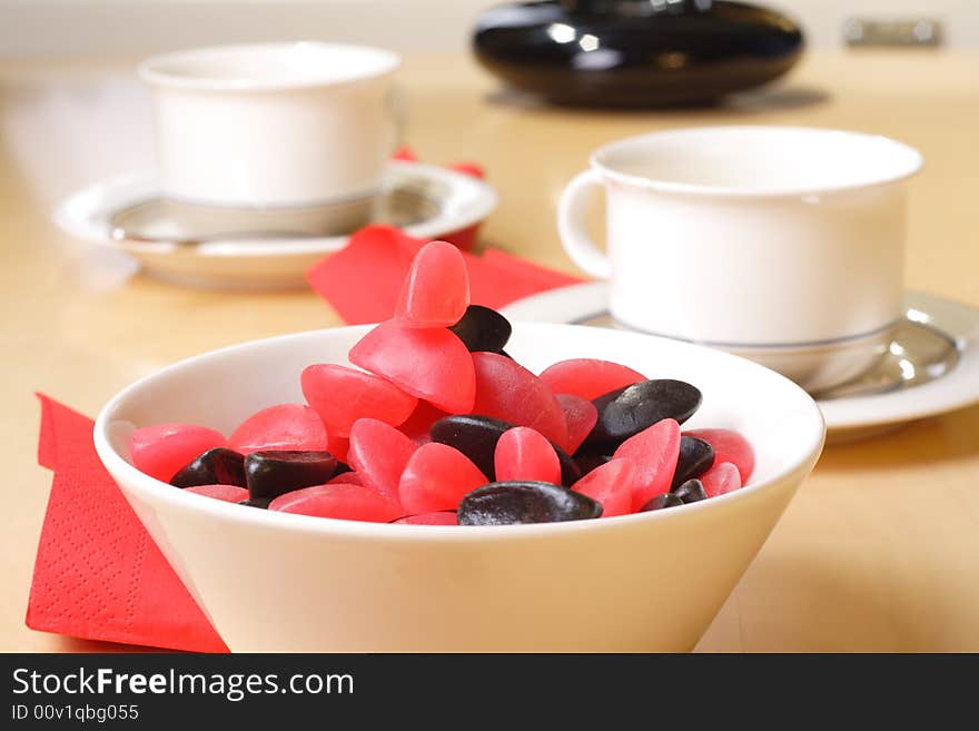 Candy with coffee cups in the background. Candy with coffee cups in the background