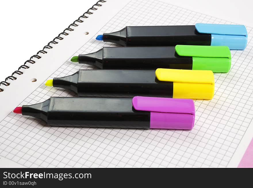 Group of color markers on notepad