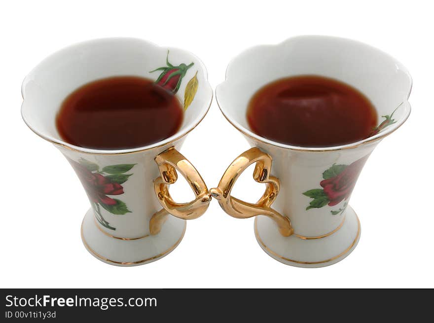 Two old china teacups with strong tea for two. Two old china teacups with strong tea for two.