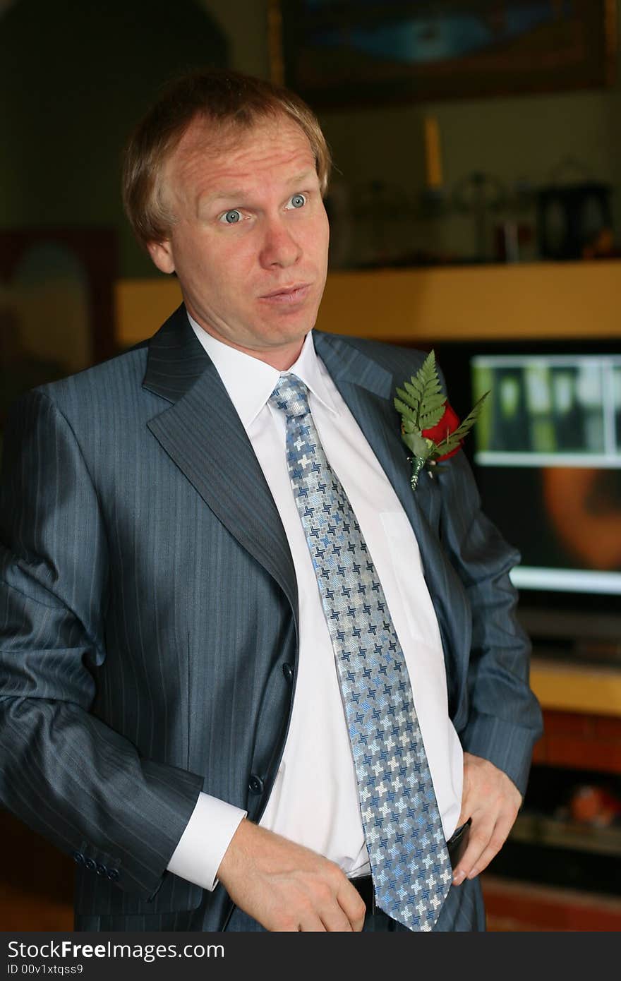 Portrait surprised men with a rose on a lapel of a jacket