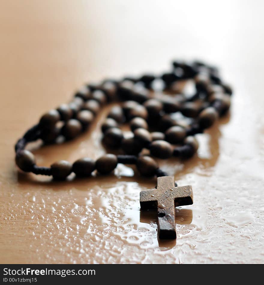 A rosary on wet background