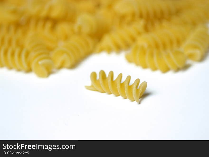 Italian fusilli pasta falling out of a glass jar