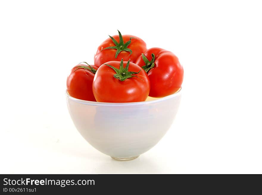 Tomatoes in the bowl on white background