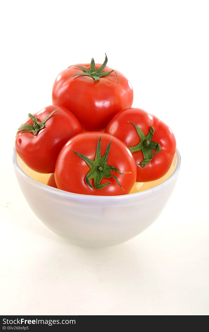 Tomatoes in the bowl on white background