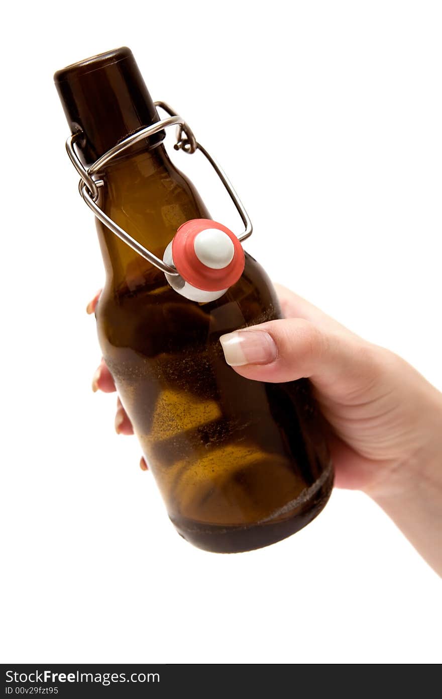 Female hand holding an opened beer bottle. Isolated on a white background. Female hand holding an opened beer bottle. Isolated on a white background.