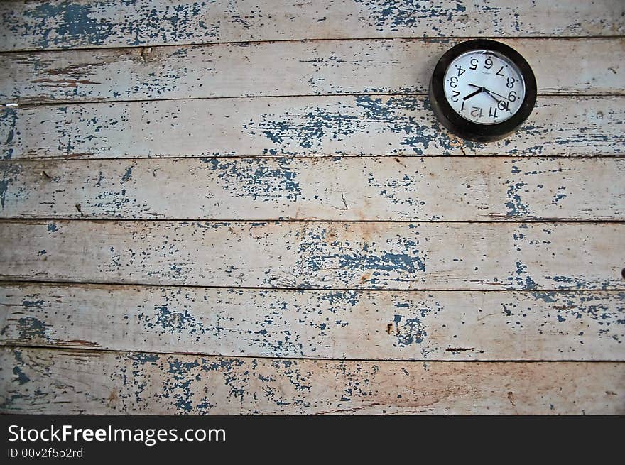 A broken clock on a decaying wall