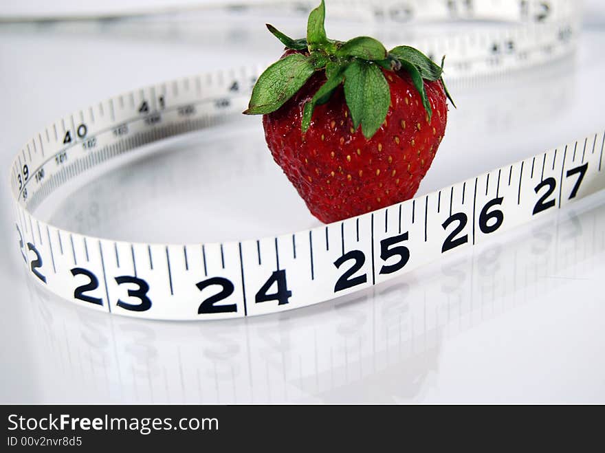 Single strawberry with measuring tape. Single strawberry with measuring tape.