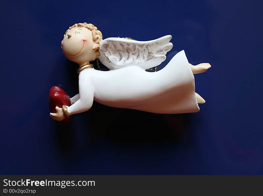 Cheerful doll-angel with heart in hands. Cheerful doll-angel with heart in hands.